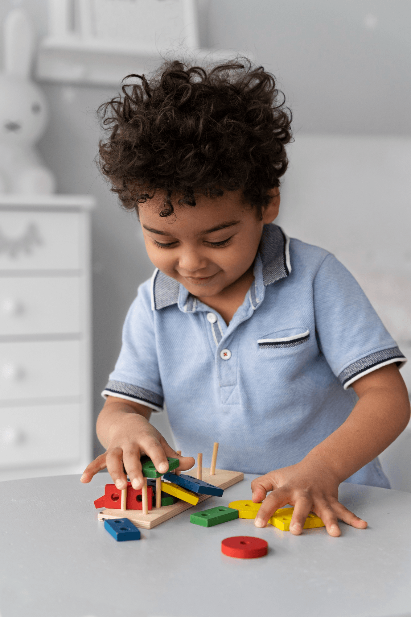 Boy exploring wooden toys