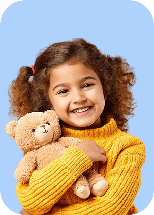 Smiling girl hugging a teddy bear