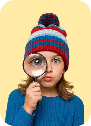 Curious child looking through a magnifying glass